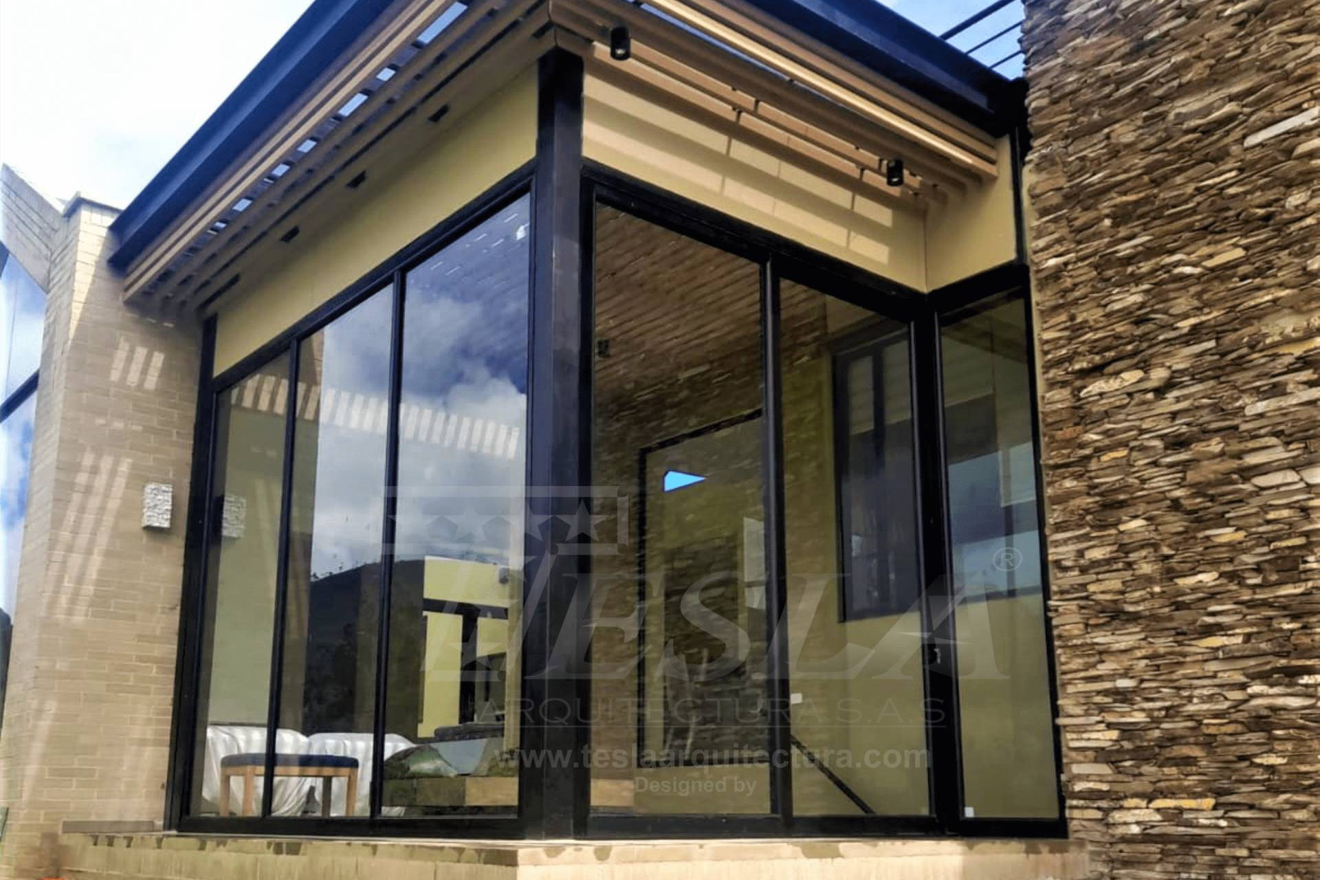 Puertas de vidrio, fachadas y cerramientos en acero y vidrio en la propuesta de Tesla Arquitectura